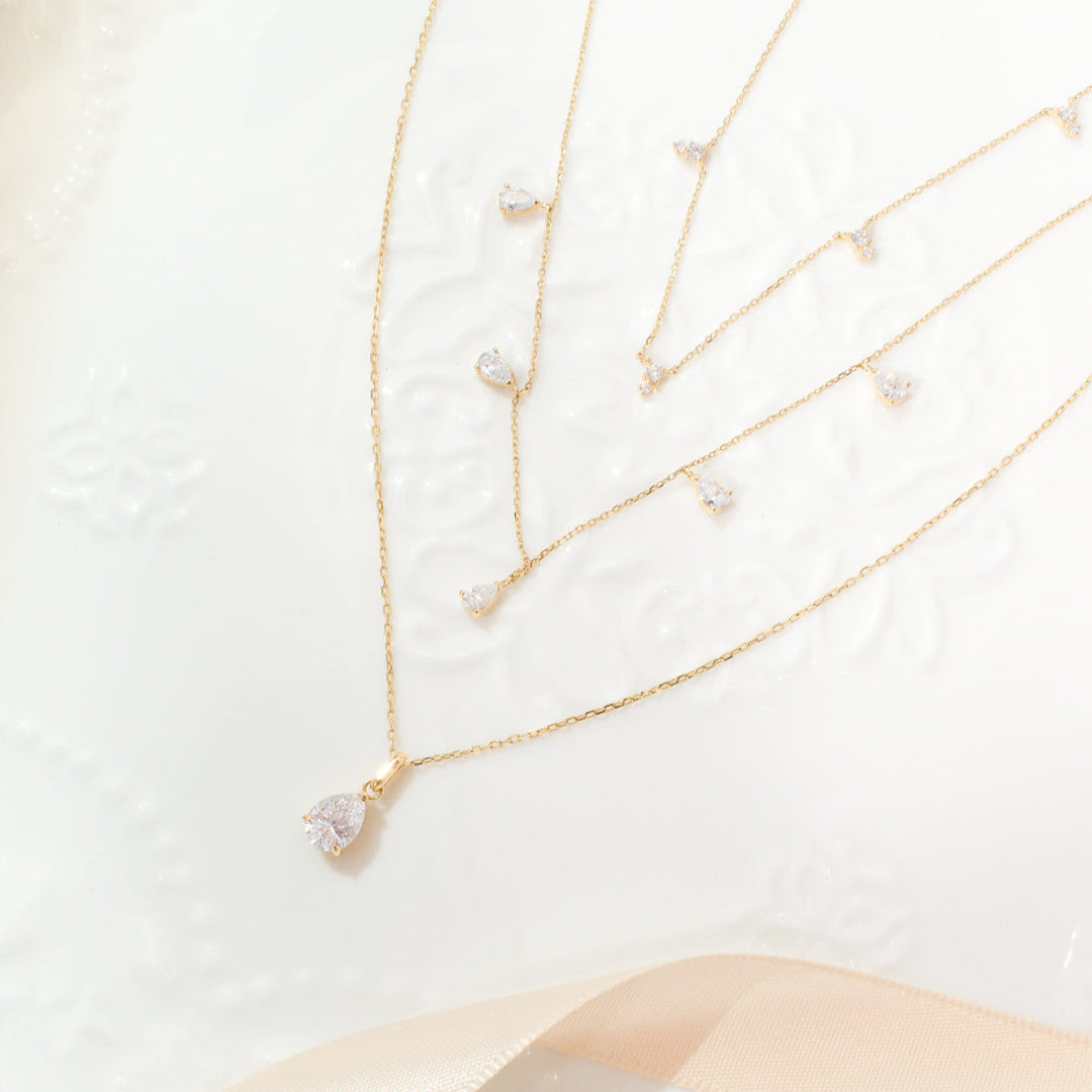 Close-up of solitaire pear lab-grown diamond necklace, a sustainable and sparkling gift idea
