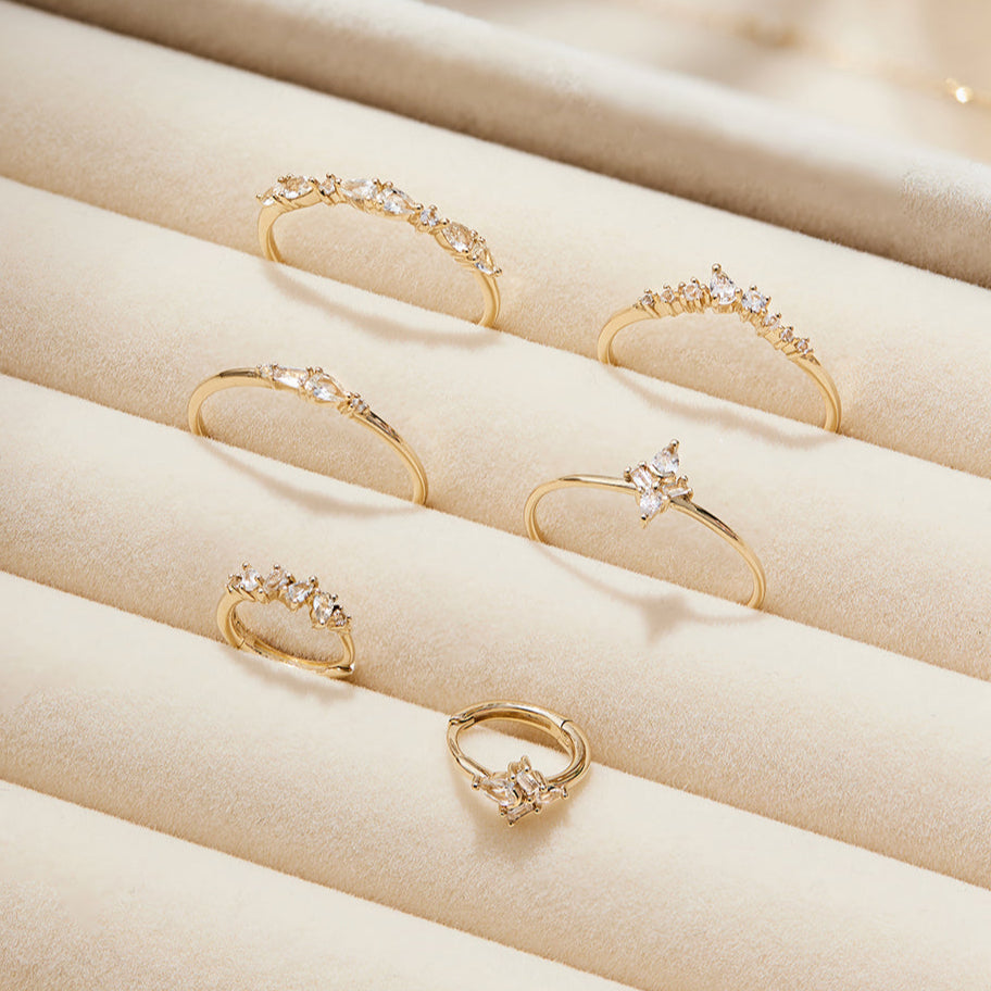 Close-up of white sapphire ring with baguette and pear cuts, adding elegant drama to any look